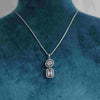 Baguette and Round Cluster Pendant surrounded by One Row Halo With Chain
