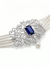 choker-style pearl and diamond necklace featuring a stunning deep blue gemstone centerpiece