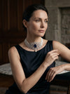 choker-style pearl and diamond necklace featuring a stunning deep blue gemstone centerpiece
